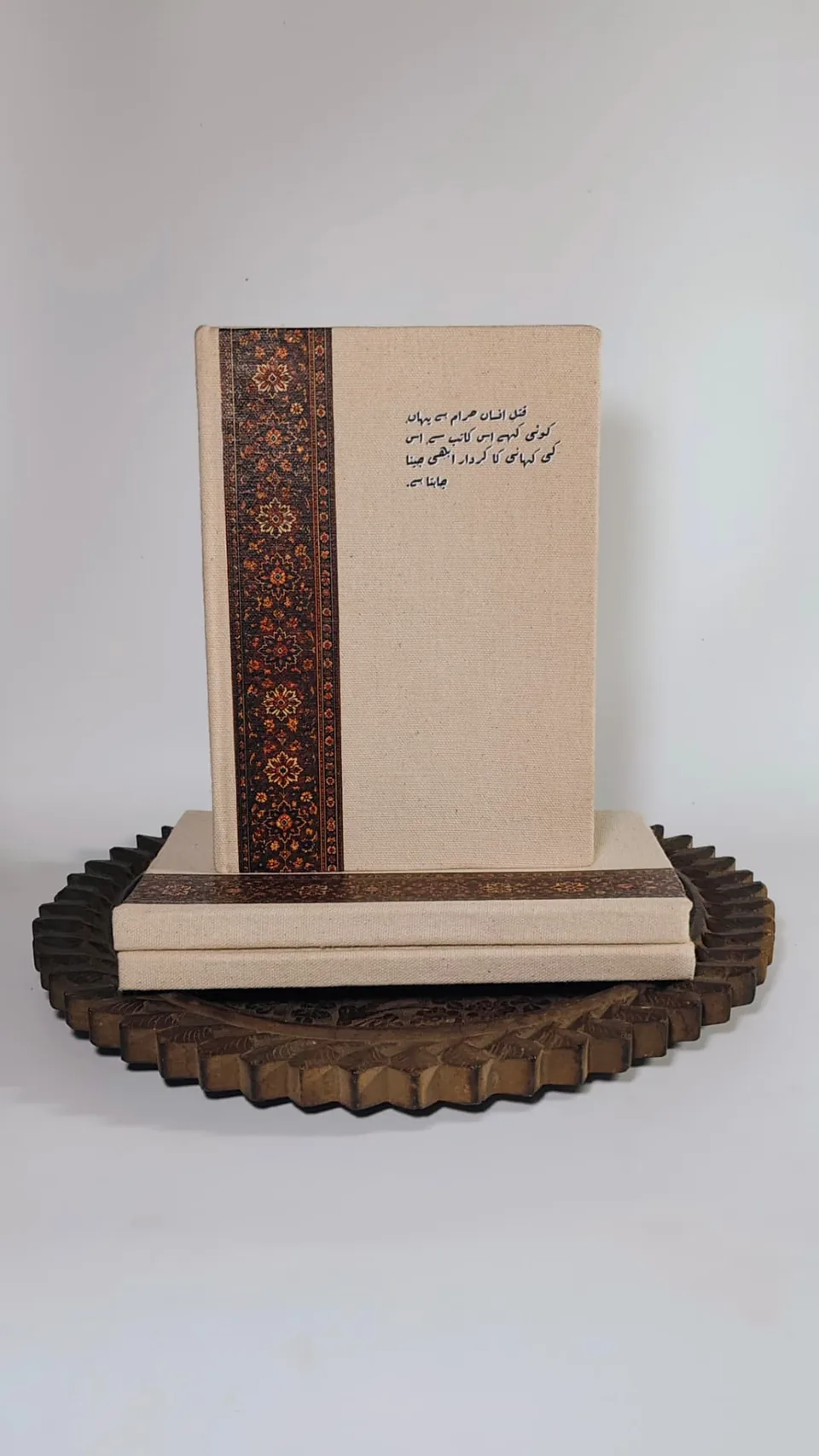 Three Kaatib diaries stacked, one standing upright to show the cover